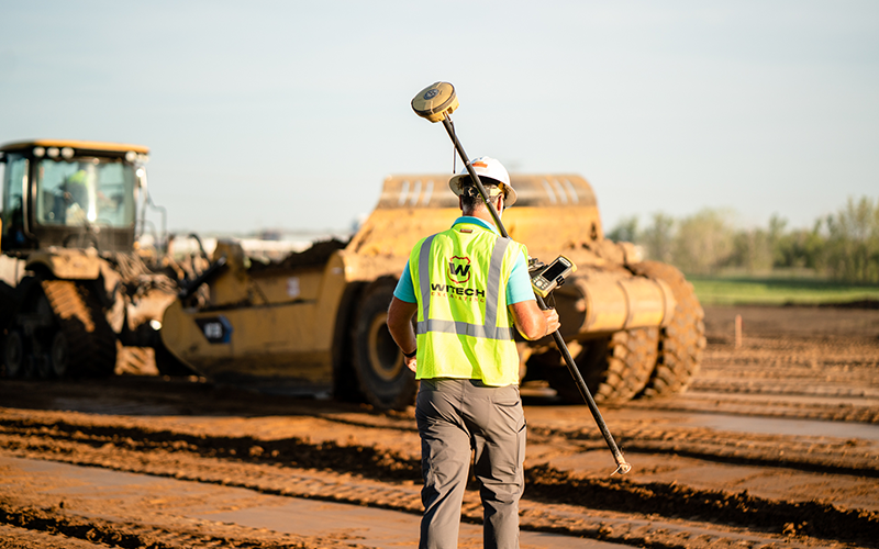 WITECH Crew Holding Earthwork Equipment On Construction Project Site